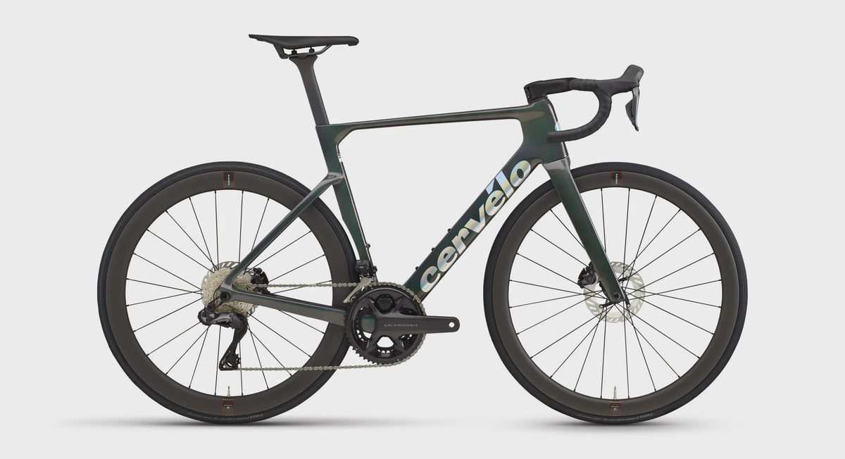 Dark green road bike with drop handlebars and black wheels
