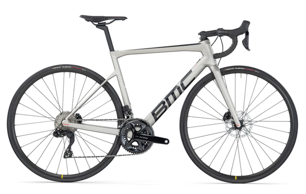 Road bicycle with grey frame, black wheels, and red accents, side view