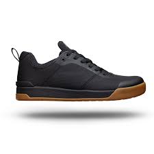Women’s lace-up sneakers with dark upper and tan rubber sole